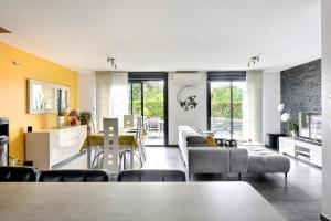 a living room with a couch and a table at FAA'mily Home, 3 bedrooms, meublé de tourisme 4 étoiles in Offemont