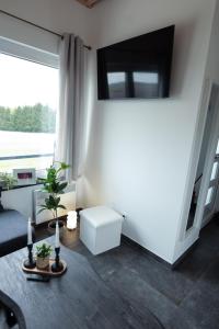 a living room with a large window and a couch at Ferienhaus Kisselblick in Bad Salzungen