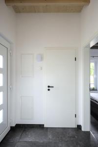 a white door in a white room with a window at Ferienhaus Kisselblick in Bad Salzungen