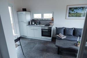 a kitchen with a couch and a sink in a room at Ferienhaus Kisselblick in Bad Salzungen