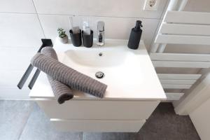 a white bathroom sink with two towels on it at Ferienhaus Kisselblick in Bad Salzungen +16 photos