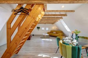 a staircase in a living room with a table and chairs at Alte Post in Münsingen
