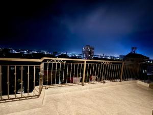 a balcony with a view of a city at night at Royal Hotel Hà Nội in Lưu Phái