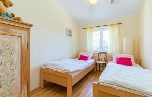 a bedroom with two beds with pink pillows at House Moreda by Istrialux in Vodnjan +39 photos