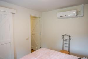 a white room with a bed and a fan at Charming Vacation Home Spier in Spier