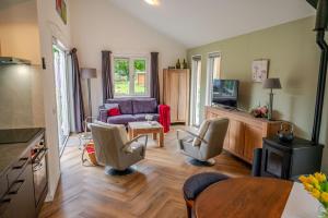 a living room with a couch and a table at Charming Vacation Home Spier in Spier