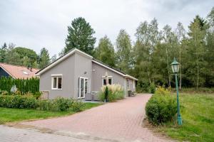 a house on a brick road with a street light at Charming Vacation Home Spier in Spier