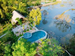 an overhead view of a swimming pool in a river at Van Long Garden Retreat in Kon Rung (1)