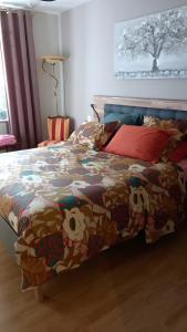 een slaapkamer met een bed met een kleurrijk dekbed bij Chambre D'hôtes De La Gandonnière in La Duchaie +11 foto's