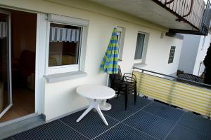 a small white table and chair on a balcony at Ferienwohnung Schuhmacher in Donaueschingen