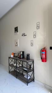 a shelf with pots and pans on a white wall at استراحة أُنس in Hail