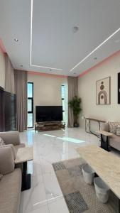 TV a/nebo společenská místnost v ubytování استراحة أُنس