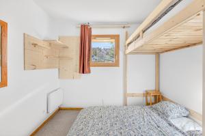 a bedroom with a bed and a window at appartement Superdevoluy in Superdevoluy