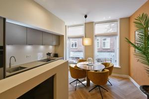 a kitchen and dining room with a table and chairs at Jorisz Apartments in Haarlem