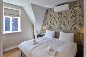 Postel nebo postele na pokoji v ubytování Jorisz Apartments