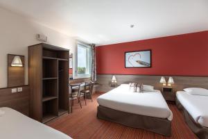 a hotel room with two beds and a red wall at Ace Hotel Chateauroux Déols in Déols