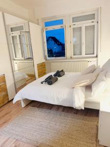 a bedroom with a white bed and a window at Cosy Living in Vallendar Central and Peaceful in Vallendar