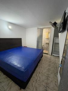 a bedroom with a blue bed in a room at Space Tour in Cabo Frio