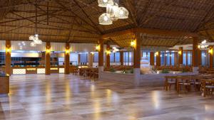 a large room with tables and chairs and a fountain at JAZ Adonia in Uroa