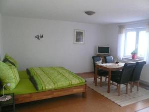 a bedroom with a bed and a table with chairs at Ferienwohnung Bio-Bauernhof Schuwerk in Isny im Allgäu