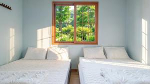 En eller flere senge i et værelse på Gapyeong Four Season Pension