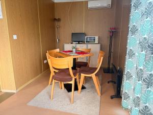 a table and chairs in a small room at GreenPark Tiny House, Garden Terrace & Parking in Bekecs +6 photos