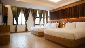 Postel nebo postele na pokoji v ubytování Hotel M7 Plaza