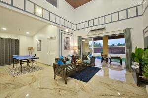 a living room with a ping pong table at EKOSTAY - Pinewood Villa in Alibaug