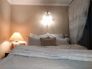a bedroom with a large bed with white sheets and pillows at Тиха гавань в чарівному містечку in Korsun'-Shevchenkivs'kyy +8 photos