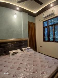 a large bed in a room with a window at Green Valley Residency in Lucknow
