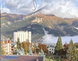 a view of a city with a mountain in the background at Central Guest in Sauze dʼOulx
