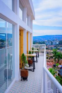 a balcony with a table and chairs on a building at Luma & Lua Boutique Hotel in Kigali