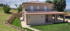 a house with a garage and a fence at Casa Alysa Agriturismo in Tavullia