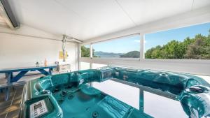 a tub in a room with a large window at Ganghwa Giverny Spa Pension in Incheon