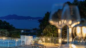 a bench and a fence with a view of the water at Ganghwa Giverny Spa Pension in Incheon +2 photos