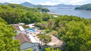 an aerial view of a resort with a beach and water at Ganghwa Giverny Spa Pension in Incheon