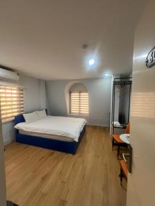 a bedroom with a bed and a television in it at Netcoe Hotel in Hanoi