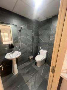 a bathroom with a white toilet and a sink at Netcoe Hotel in Hanoi