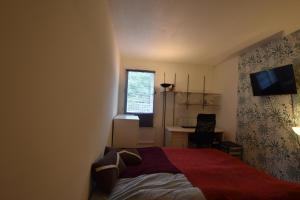 Giường trong phòng chung tại Appartement SANNOIS