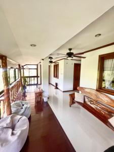 a living room with two beds and a ceiling fan at CED Garden in El Nido