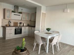 a kitchen and dining room with a white table and chairs at Exceptional sea view! Comfortable apartment in La Celle-sous-Gouzon