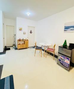 a living room with a table and chairs at Selah Stay in Manolo Fortich