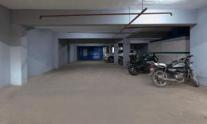 an empty parking garage with motorcycles parked in it at Treebo Golden Bliss in Pondicherry +38 photos
