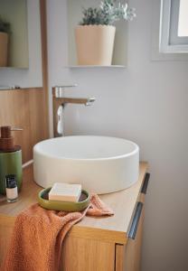 a bathroom with a white sink on a counter at Camping O'Aka in Leyme +26 photos