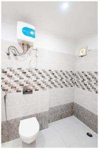a bathroom with a toilet and a wall with birds at Hotel Seabeachdreamland Heights Near jagannath Temple - Restaurant & Parking - Fully Air Conditioning Rooms - Best Hotel in Puri