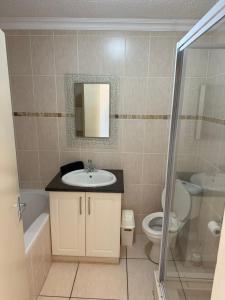 a bathroom with a sink and a toilet at 222 Laguna La Crete in Margate