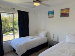 a bedroom with two beds and a window at 222 Laguna La Crete in Margate