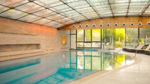 a large swimming pool in a building at Lucknam Park, Emblems Collection in Chippenham