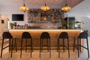 a bar with four stools in front of it at Studio Del Telegrafo in Labin