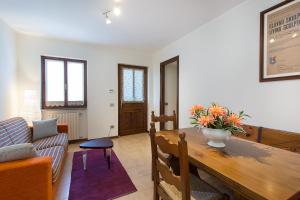 a living room with a table and a couch at Casa Nico Magognino - WiFi in Stresa +14 photos